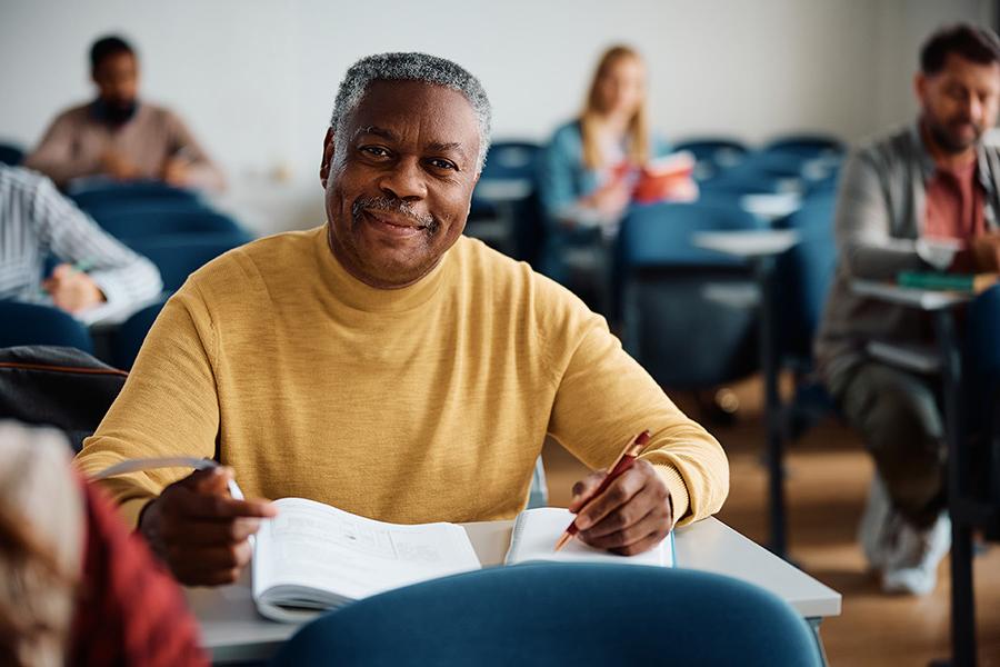 An elderly African America man sitting in a Continuing Education class